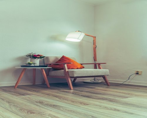 A cozy reading corner with a warm desk lamp and a book